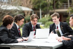 ERC-group-of-students-work-at-outdoor-table-with-their-laptops